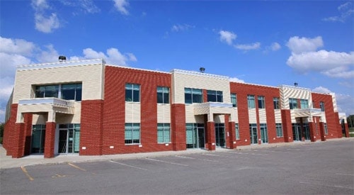 brick red and off white colour building, rectangles of each colour on different parts of the building