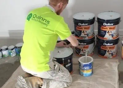 Guy mixing dulux paint pic2