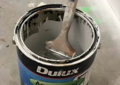 Paint brush sitting in Dulux aquanamel paint can
