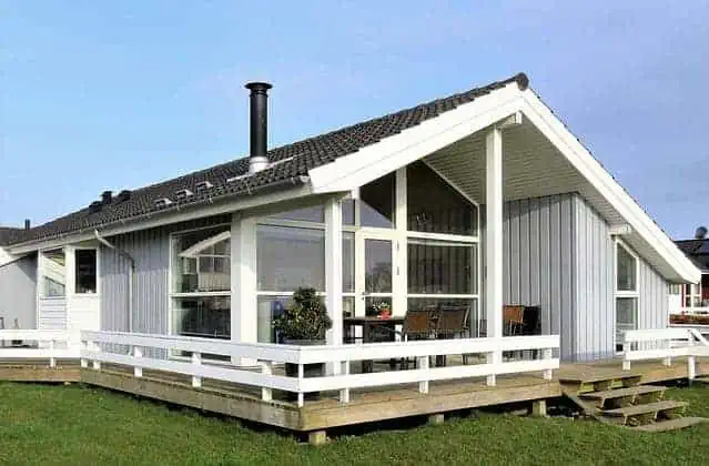 lovely white and black single story home with deck and big windows