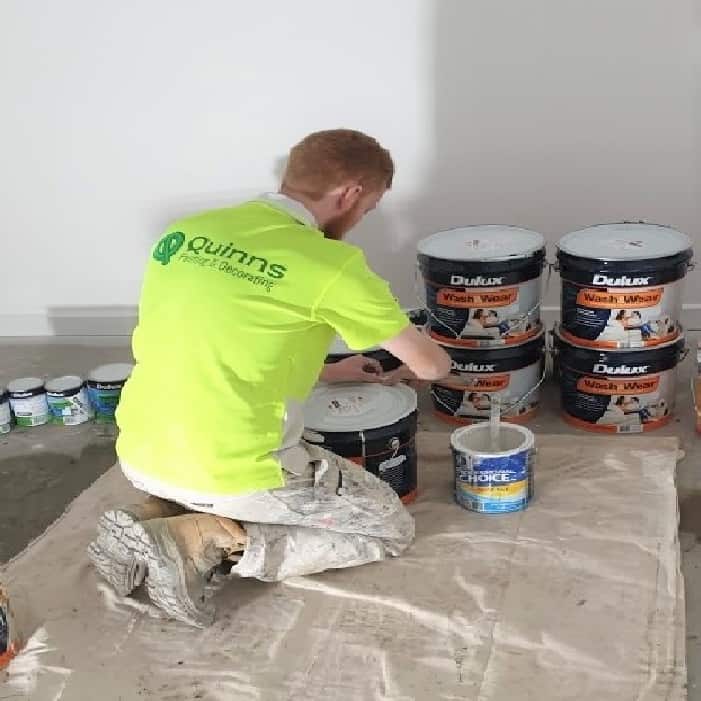 Guy mixing dulux paint