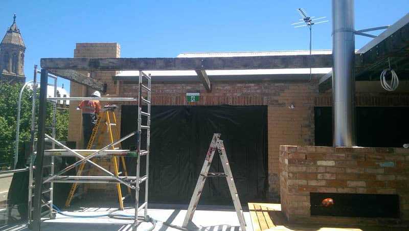 Removing render off bricks of house