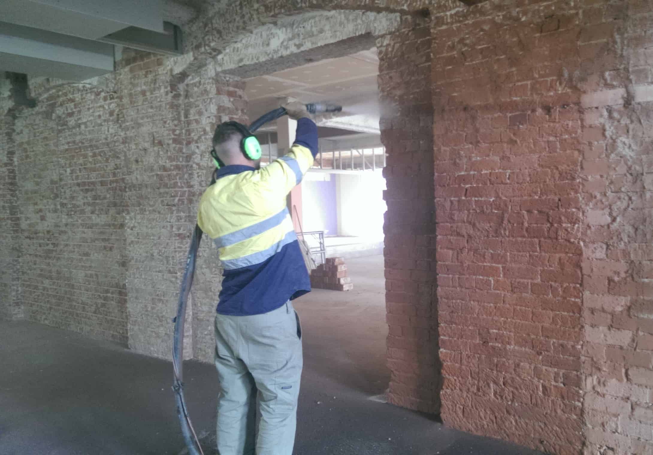 Cleaning brick wall by sandblasting - Sandblasting Cost Blog