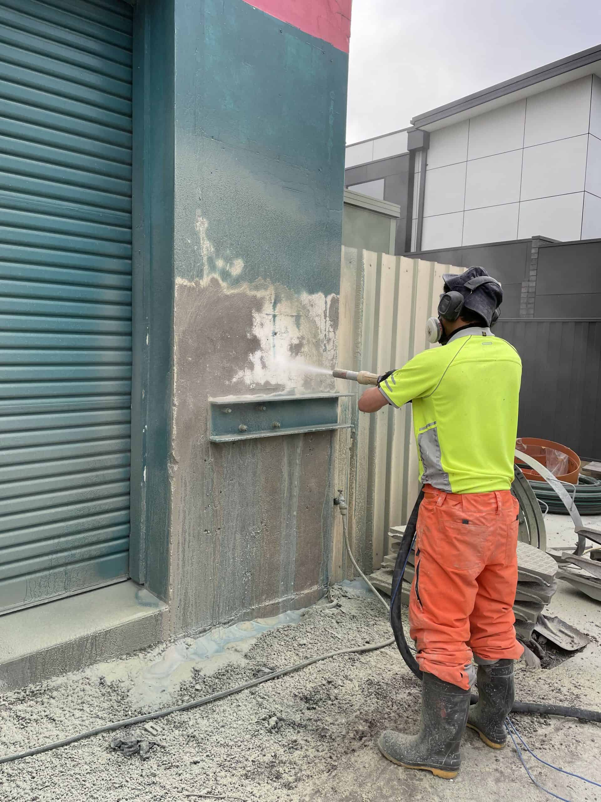 Industrial sandblasting of building